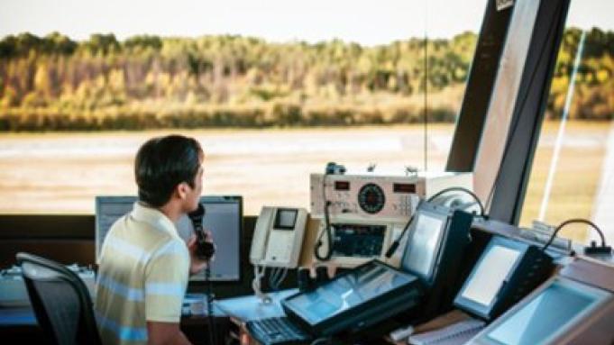 Air traffic controller in the flight tower working with instruments